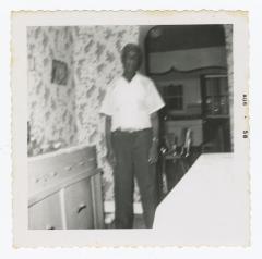 Blurry picture of a man in a dining room