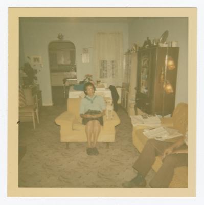 A woman, man, and dog in a living room
