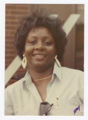 A woman smiling outside
