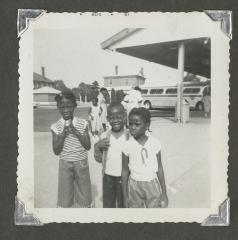 Three children waiting outside