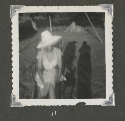 Blurry photograph of a woman in a hat