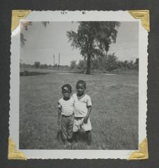 Two young children with their arms around the other