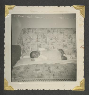 A young baby laying on a couch