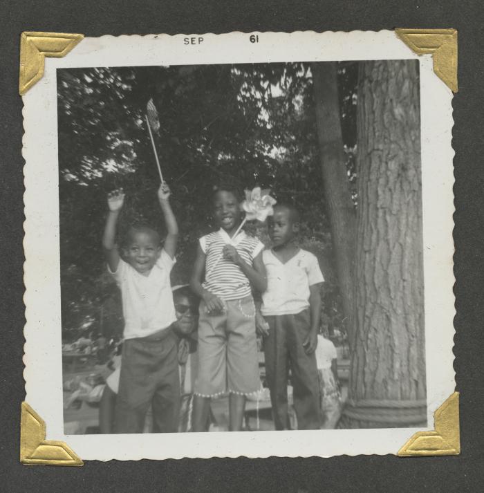 Children and an adult at an outdoor celebration
