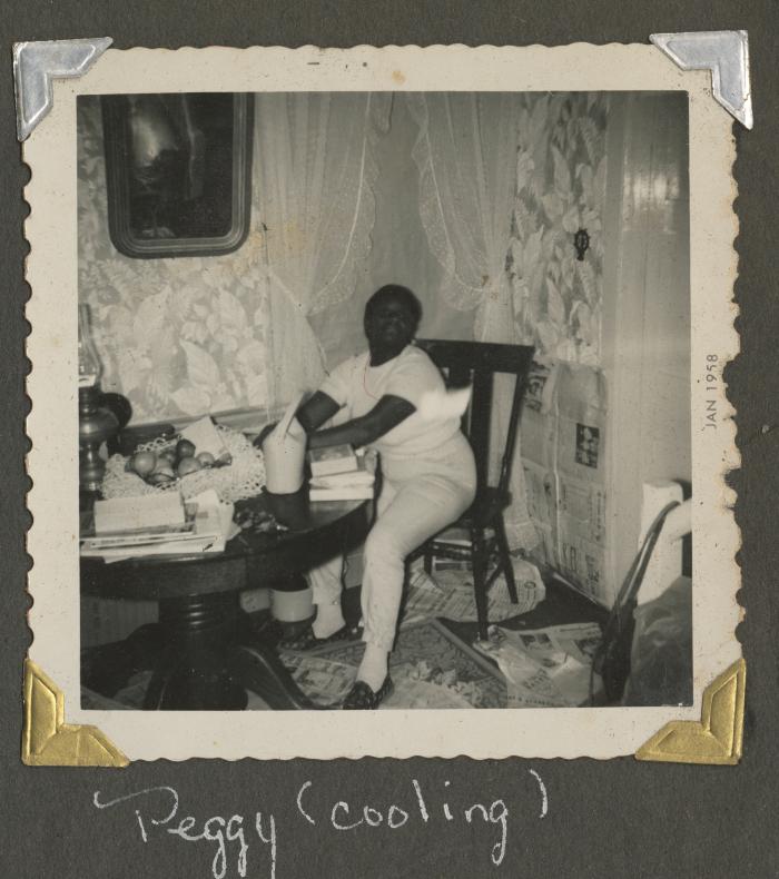 Peggy sitting in a dining room