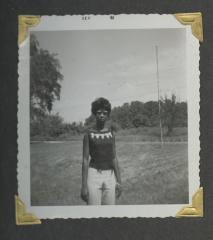 A woman in a grassy field
