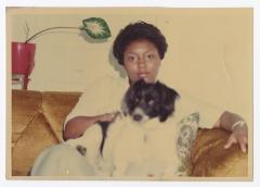 A woman with a black and white dog on her lap