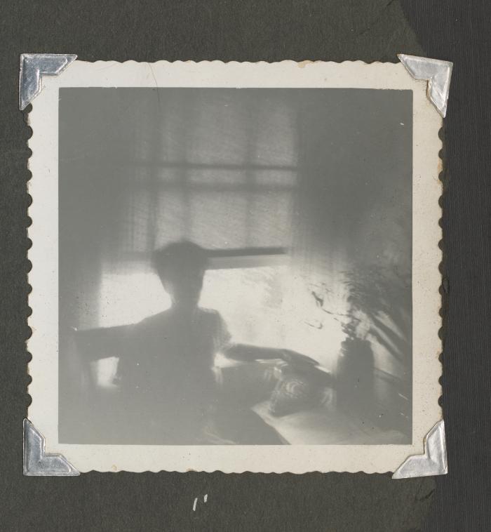Shadowy image of a woman by an open window