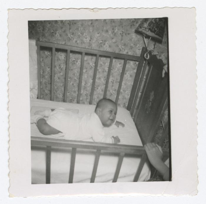 A young baby in a crib