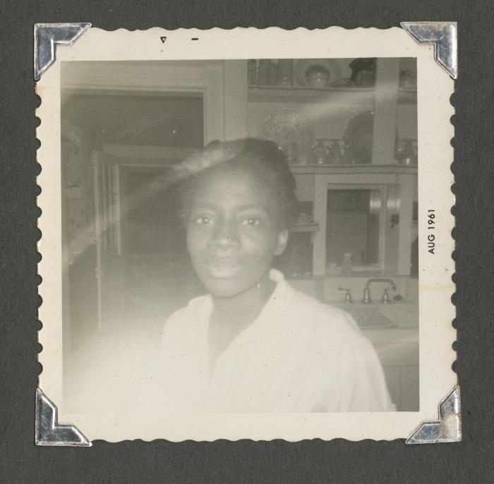 A close-up picture of a woman in a kitchen