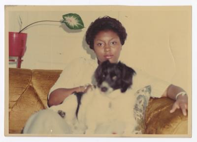 A woman with a black and white dog on her lap