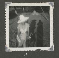 Blurry photograph of a woman in a hat