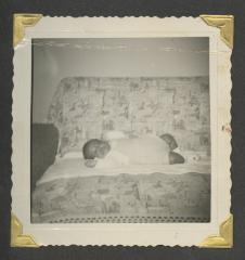 A young baby laying on a couch