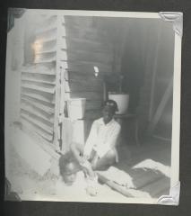 A young girl on a porch with a child