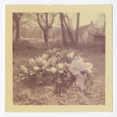 A white flowered wreath on a grave