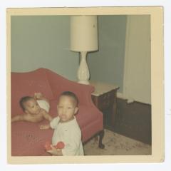 A baby and a toddler playing