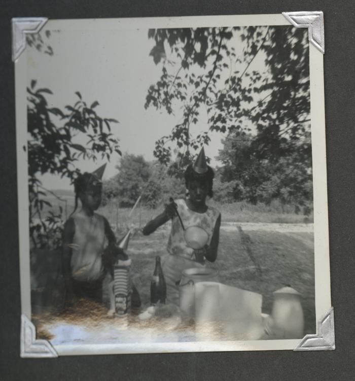 Two young girls at an outdoor birthday celebration