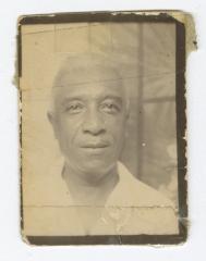 Headshot of a man in a white collared shirt
