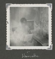 Harriette reading by a window