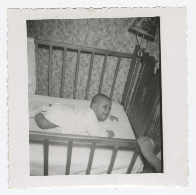 A young baby in a crib