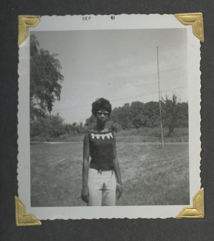 A woman in a grassy field