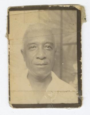 Headshot of a man in a white collared shirt