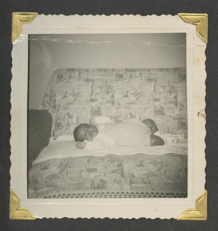 A young baby laying on a couch