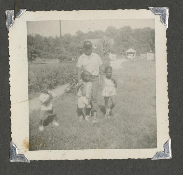 Three children and a man outside