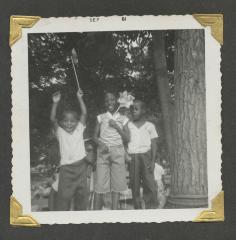 Children and an adult at an outdoor celebration