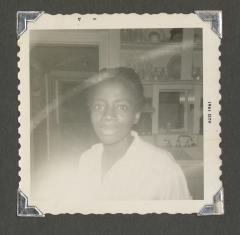 A close-up picture of a woman in a kitchen