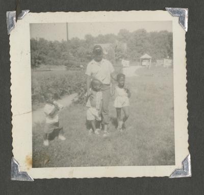 Three children and a man outside