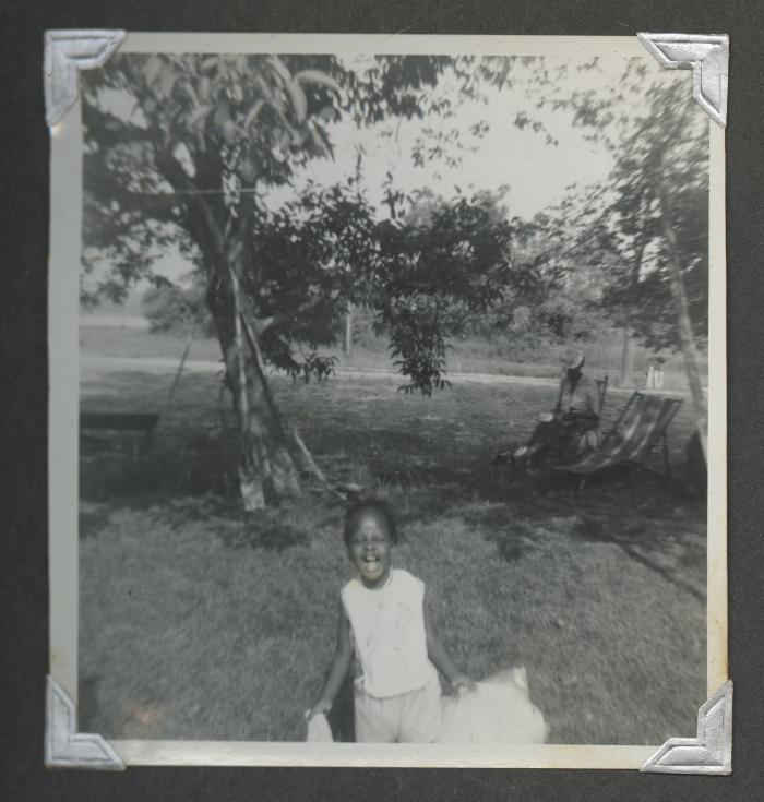 A young girl smiling widely