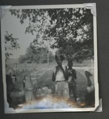 Two young children standing at an outdoor birthday celebration