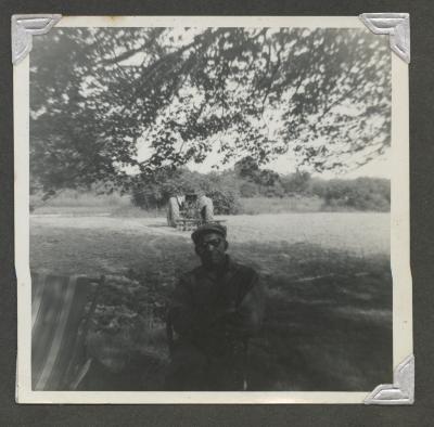 An older man sitting outside