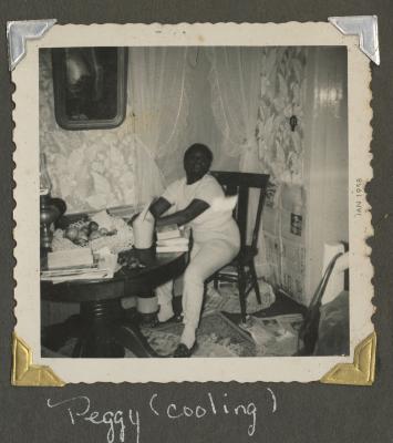Peggy sitting in a dining room
