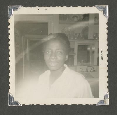 A close-up picture of a woman in a kitchen