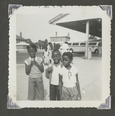 Three children waiting outside