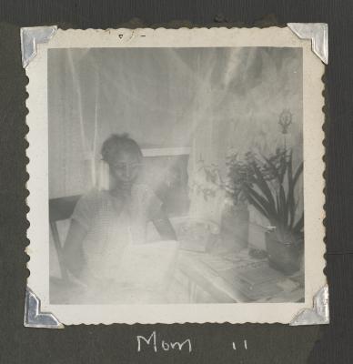 A woman sitting by a window 