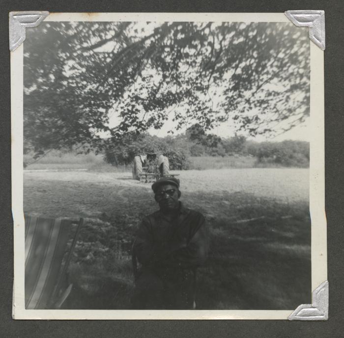 An older man sitting outside