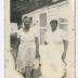 Two women standing outside a house