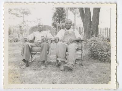 Two older men in chairs outside