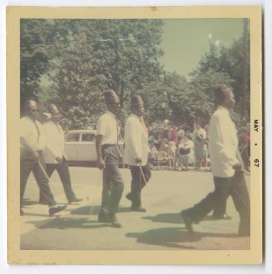 Men carrying sticks and marching