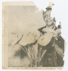 An older woman with a plant in a vase