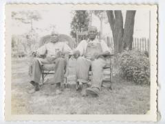 Two older men in chairs outside