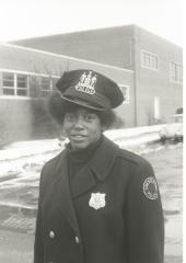 Unidentified African American female police officer acting as a crossing guard for Garnet School