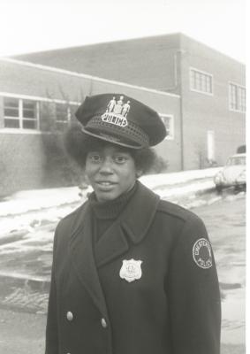 Unidentified African American female police officer acting as a crossing guard for Garnet School