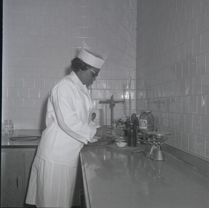 Fenwick Wilson conducts quality assurance work on pickles packed at Vita Foods plant