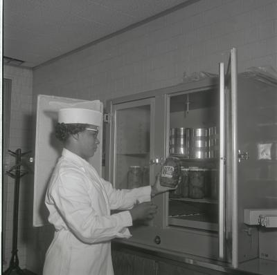 Geraldine Brooks - Fenwick inspects a jar of pickles for Vita Foods production