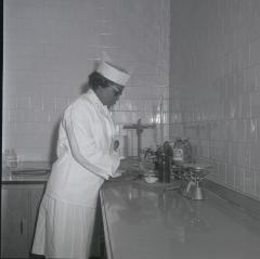 Fenwick Wilson conducts quality assurance work on pickles packed at Vita Foods plant