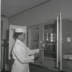 Geraldine Brooks - Fenwick inspects a jar of pickles for Vita Foods production